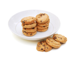 A stack of chocolate chip cookies in plate on a white background