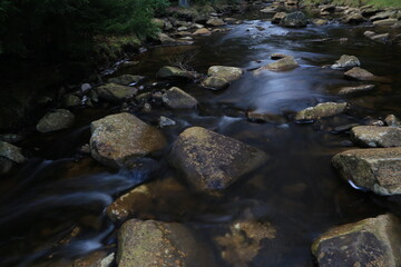 Fototapeta na wymiar Flowing water on the rocks - waterfall river