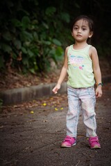 Fototapeta premium Portrait of a toddler walking outdoor. Enjoying nature.