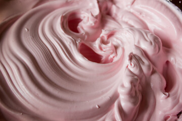 Pink cream for dessert own hands. Confectionery background.