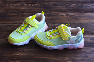 Children's sneakers for girls with a luminous sole. Comfortable and fashionable sports shoes for...