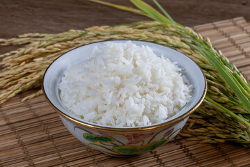 White rice (jasmine rice) in a  bowl on a wooden background
