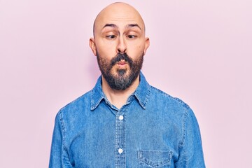 Fototapeta premium Young handsome man wearing casual clothes making fish face with lips, crazy and comical gesture. funny expression.