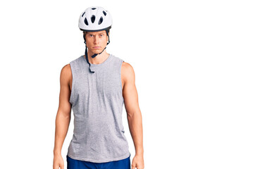 Young handsome man wearing bike helmet skeptic and nervous, frowning upset because of problem. negative person.