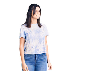 Fototapeta premium Young beautiful girl wearing casual t shirt looking away to side with smile on face, natural expression. laughing confident.