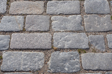 Texture of stone pavement tiles on a road.