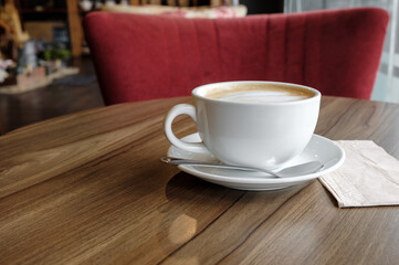 closed-up of hot drink coffee in white mug on brown wood table