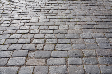 Texture of stone pavement tiles on a road.