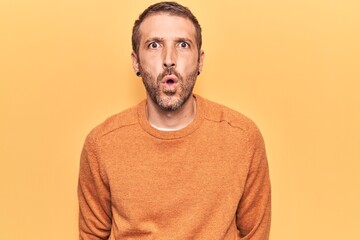 Young handsome man wearing casual clothes scared and amazed with open mouth for surprise, disbelief face