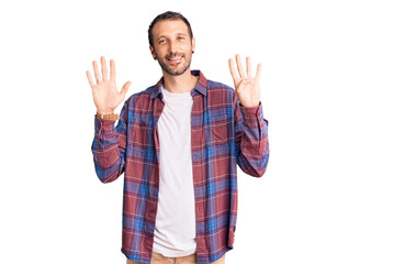 Naklejka premium Young handsome man wearing casual clothes showing and pointing up with fingers number nine while smiling confident and happy.
