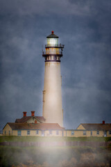 Fototapeta na wymiar Pigeon Point Light House in the fog with the light shining right into the lens of the camera