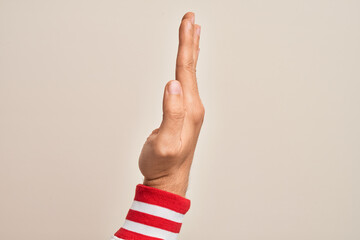 Hand of caucasian young man showing fingers over isolated white background showing the side of stretched hand, pushing and doing stop gesture