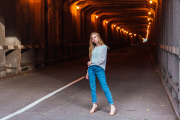 Young woman standing in a tunnel with lights