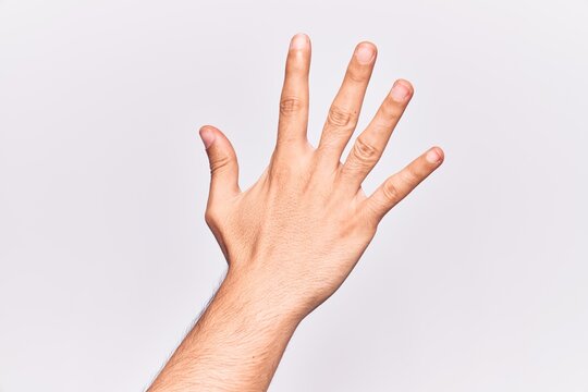Close up of hand of young caucasian man over isolated background counting number 5 showing five fingers