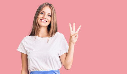 Young beautiful blonde woman wearing summer style showing and pointing up with fingers number three while smiling confident and happy.