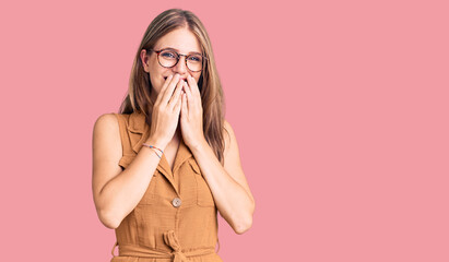 Young beautiful blonde woman wearing casual clothes and glasses laughing and embarrassed giggle...
