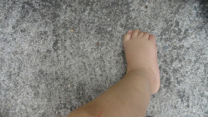 Baby foot on old cement floor background. Express the first step of everyone.