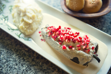 Traditional Mexican dish of chiles en nogada. Mexican gourmet food. Overhead view of chiles en nogada with mashed potatoes.