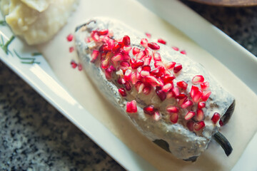 Traditional Mexican dish of chiles en nogada. Mexican gourmet food. Overhead view of chiles en nogada with mashed potatoes.