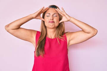 Fototapeta premium Middle age hispanic woman wearing casual clothes with hand on head, headache because stress. suffering migraine.