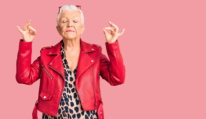 Senior beautiful woman with blue eyes and grey hair wearing a modern style with a red leather jacket relax and smiling with eyes closed doing meditation gesture with fingers. yoga concept.