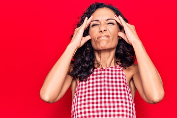 Middle age beautiful woman wearing casual sleeveless t shirt with hand on head, headache because stress. suffering migraine.