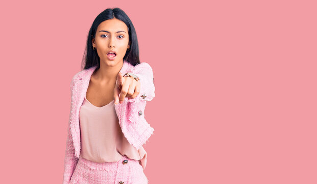 Young beautiful latin girl wearing business clothes pointing displeased and frustrated to the camera, angry and furious with you