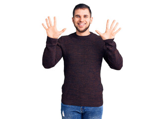 Young handsome man wearing casual sweater showing and pointing up with fingers number ten while smiling confident and happy.