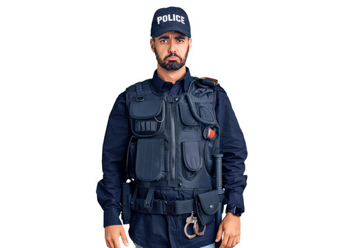Young hispanic man wearing police uniform depressed and worry for distress, crying angry and afraid. sad expression.
