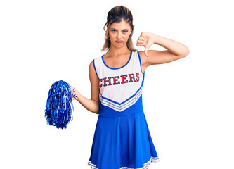 Young beautiful woman wearing cheerleader uniform looking unhappy and angry showing rejection and...