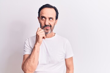 Middle age handsome man wearing casual t-shirt standing over isolated white background thinking...