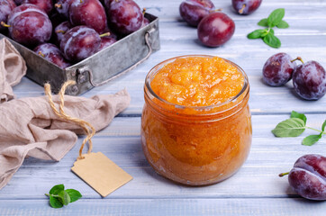Yellow plum jam in a glass jar