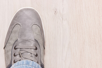 Gray shoe for men on white board, male footwear concept, copy space for text