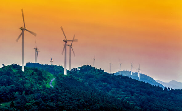 Mountain top wind turbines in Japan at sunset