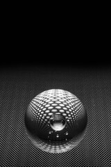 Glass ball on a surface with round holes