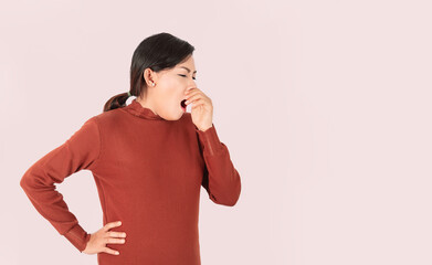 Asian woman standing open her mouth yawning on the background,