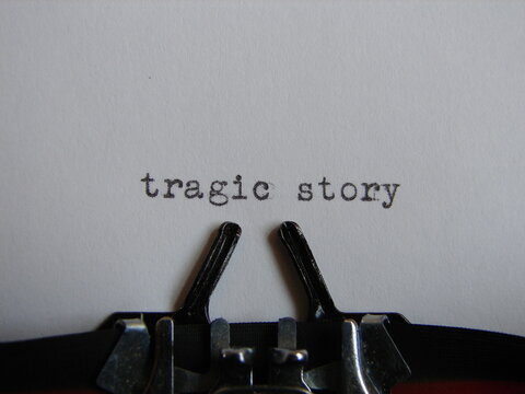 the words "tragic story" typed on a page, close up, title