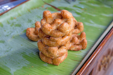 Wheels shape snack (Kanom Gong) on banana leaf.