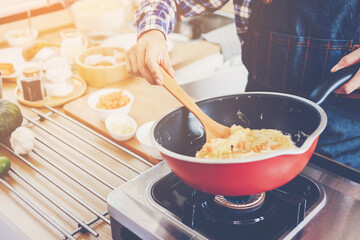 people preparing and cooking food in the home kitchen