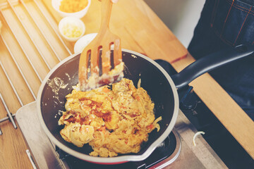 people preparing and cooking food in the home kitchen
