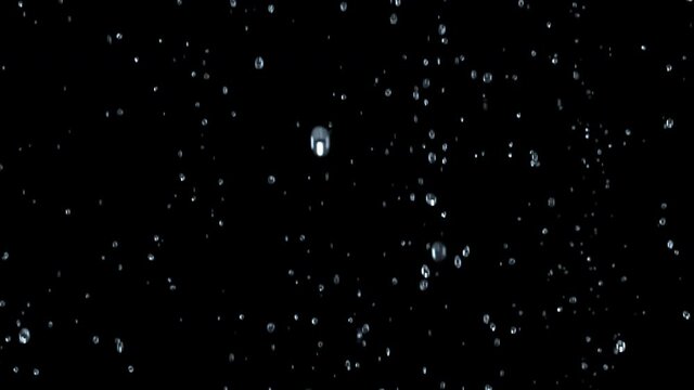 Close-up of bubbles air in under water floating up to water surface. 
The camera moves through bubbles. Isolated on black background. Alpha channel included in the end of the clip.