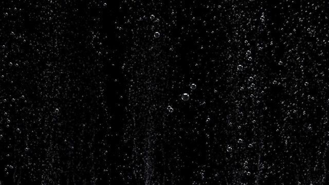 Close-up of bubbles air in under water floating up to water surface. 
The camera moves through bubbles. Isolated on black background. Alpha channel included in the end of the clip.