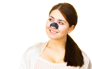 Woman applying pore strips on nose