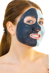 Girl with black white mud mask on face