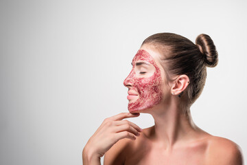 Profile portrait of woman with red nourishing mask on face. Skincare cleansing eco organic cosmetic spa relax concept