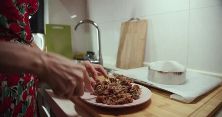 Woman mashing food with knife.