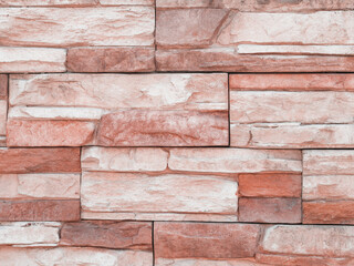 Texture of artificial stone. Stone fence. Wall in the park.