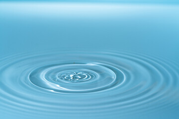 Waves on the surface of the water from a collision. Drop of water drop to the surface.