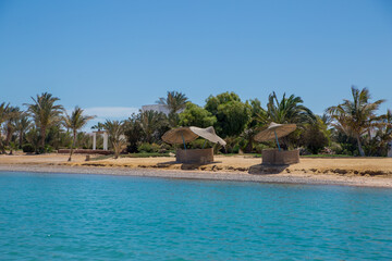 sea beach with palms and houses in egypt