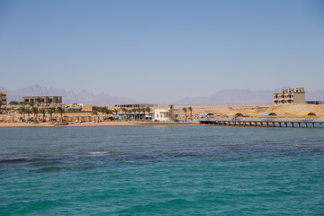 Fototapeta na wymiar sea beach with palms and houses in egypt